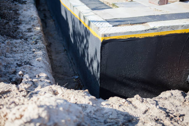 Professional Basement Waterproofing technician working in Bucks, AL